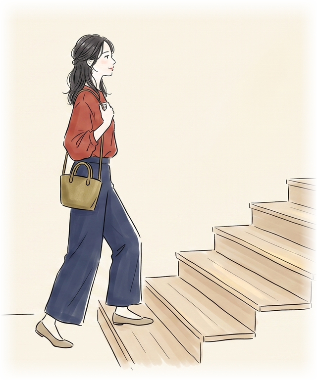 階段を上ってお店に向かう女性