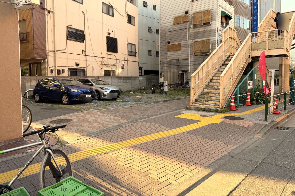 Turn left into the small street before the pedestrian bridge stairs